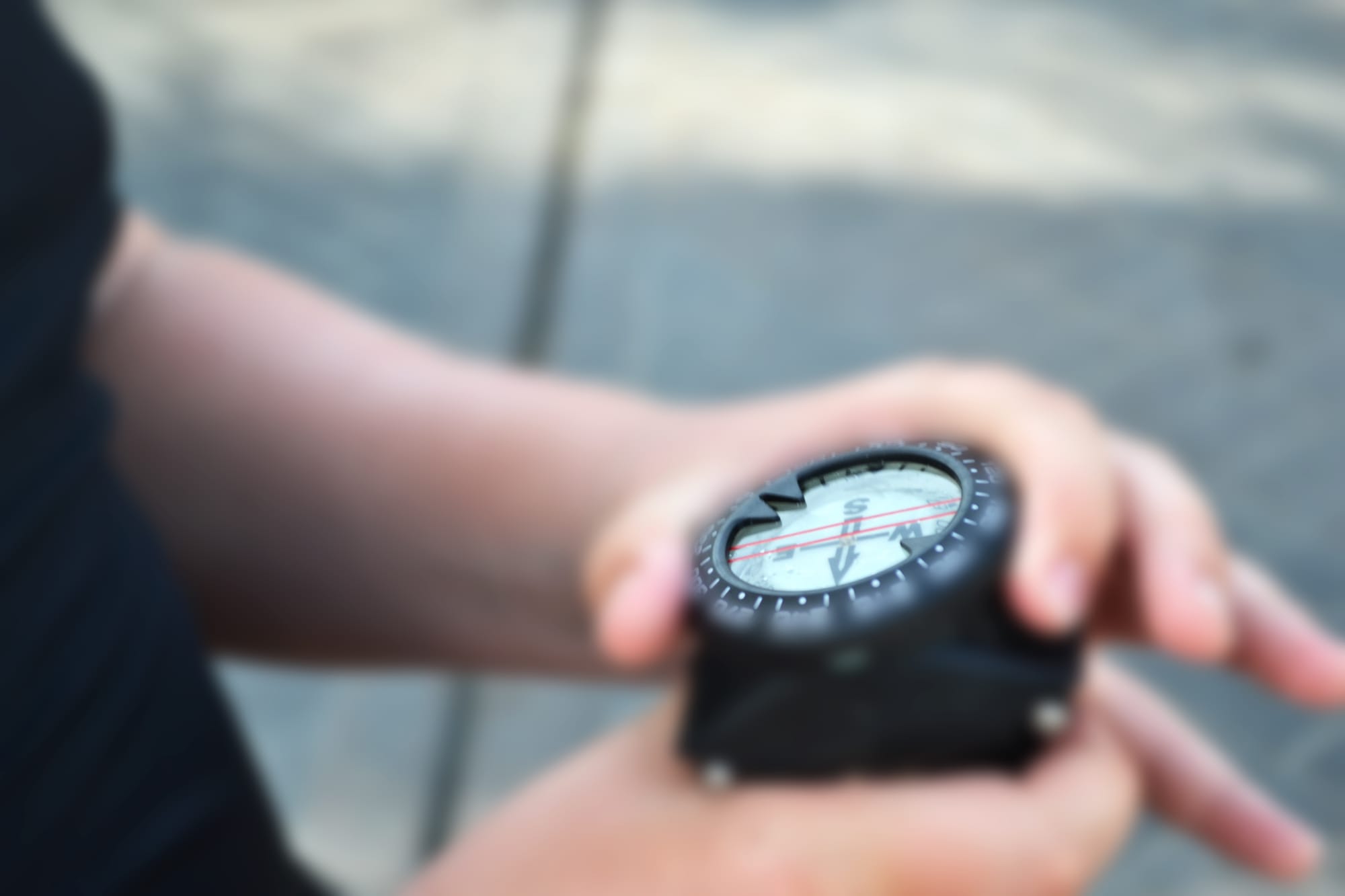 Scuba diver using a diving compass on the surface