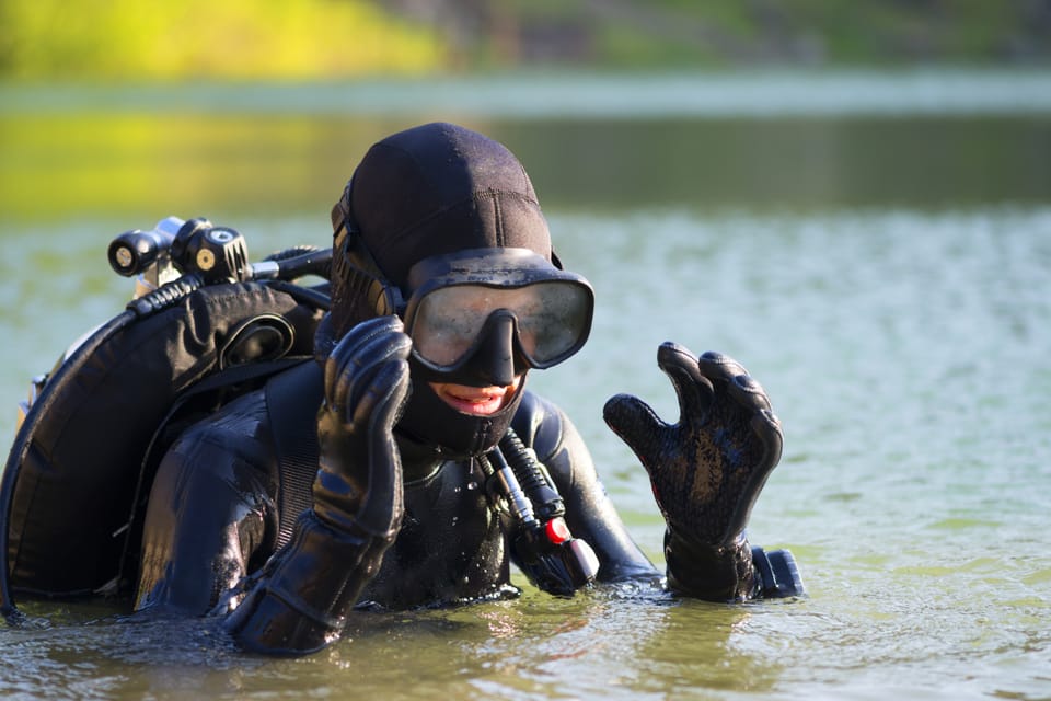Diver in a lake with a foggy scuba diving mask